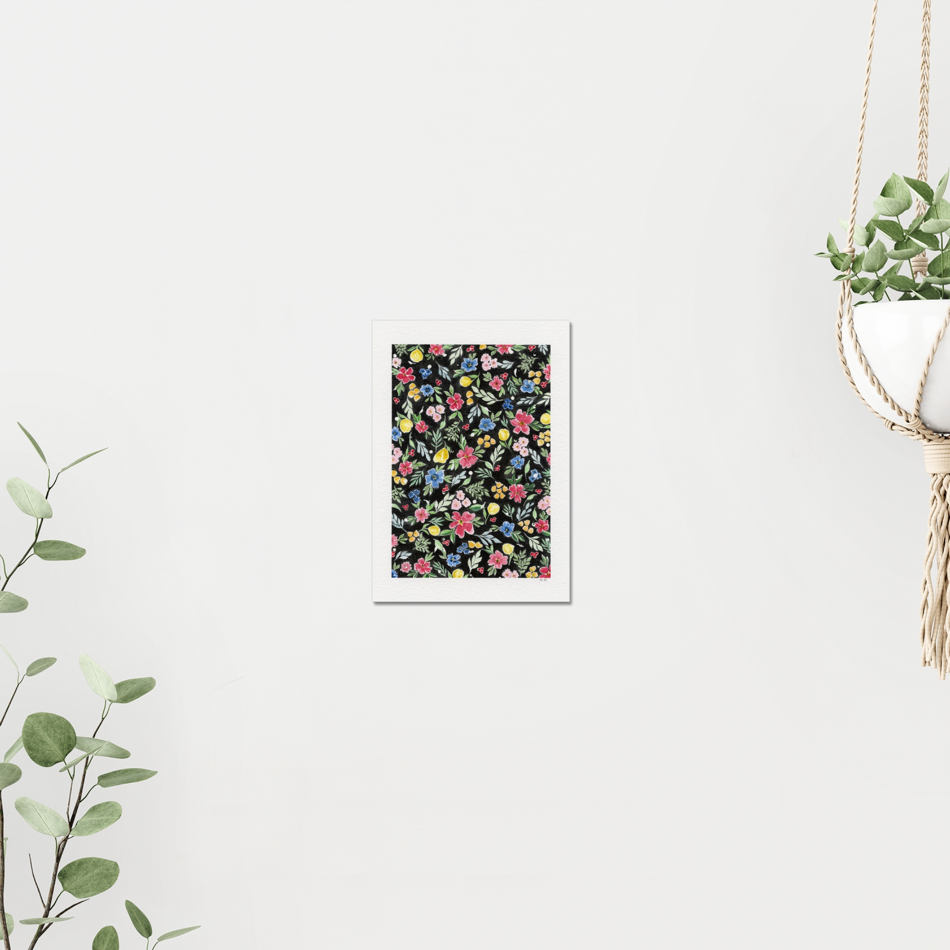 Floral pattern with colourful flowers on a black background. On white wall surrounded by plants. Made with watercolours.