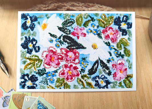 Postcard of floral illustration on oil pastel and watercolour on a wooden surface with pen, pottery, post stamps and dried plants.