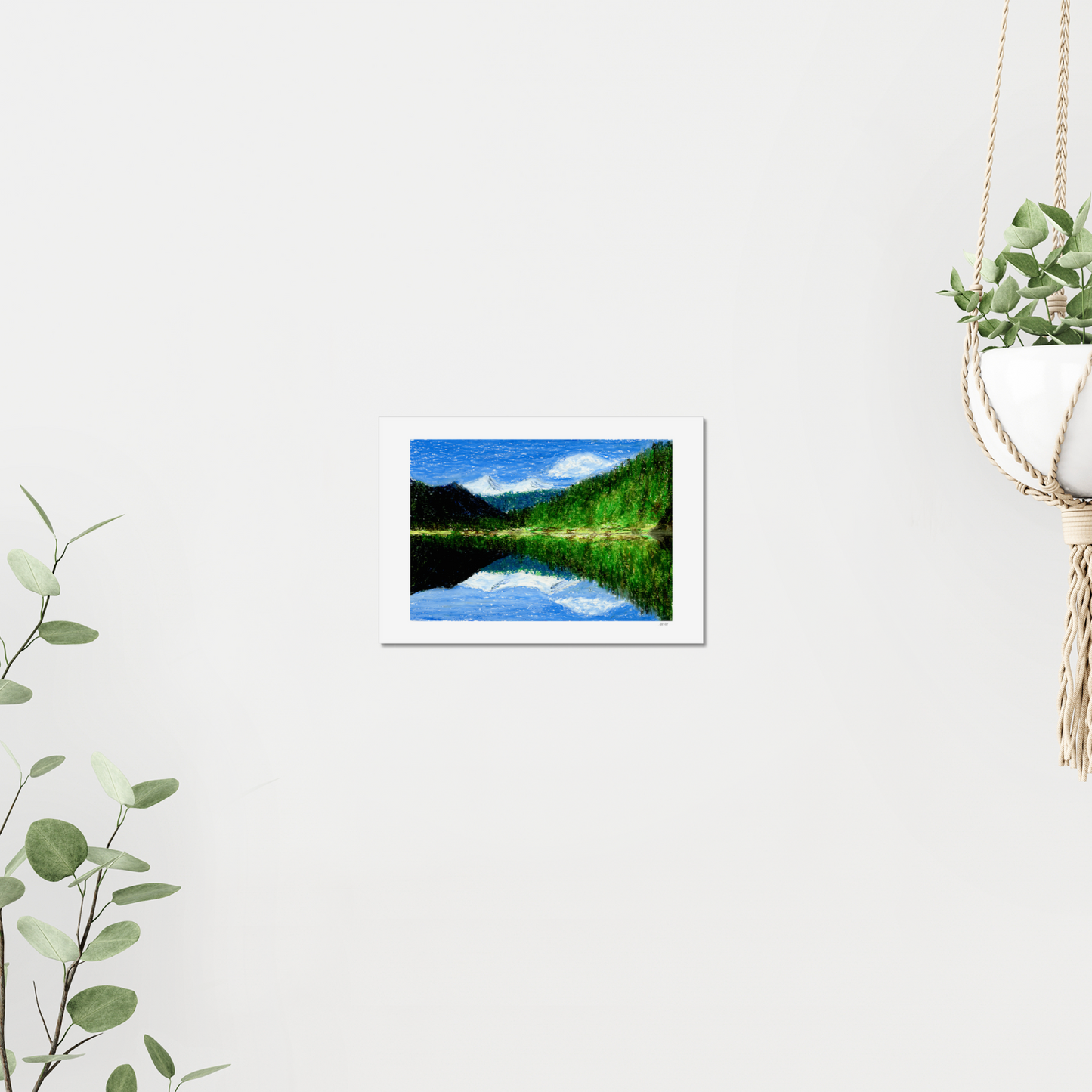 Artwork of a landscape with a lake, trees, forest, and mountains. Made with oil pastels. On a wall, surrounded by plants.