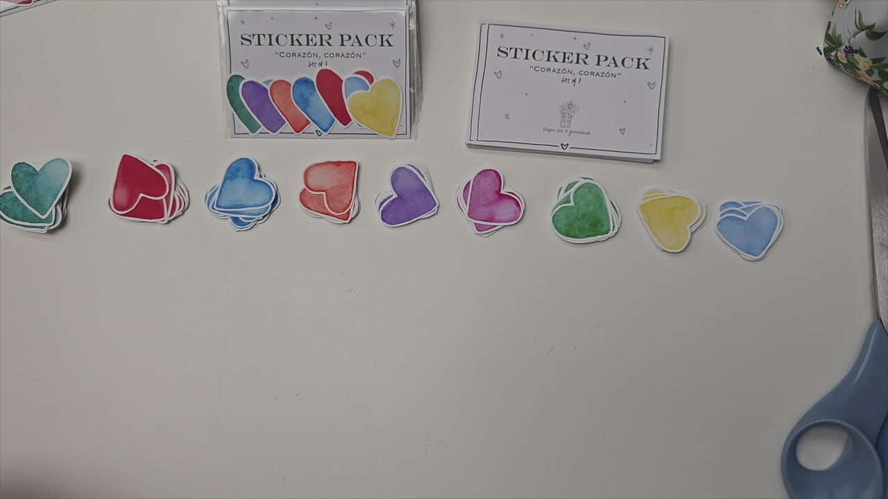 Artist putting together pack of 7 colourful, heart-shapped stickers